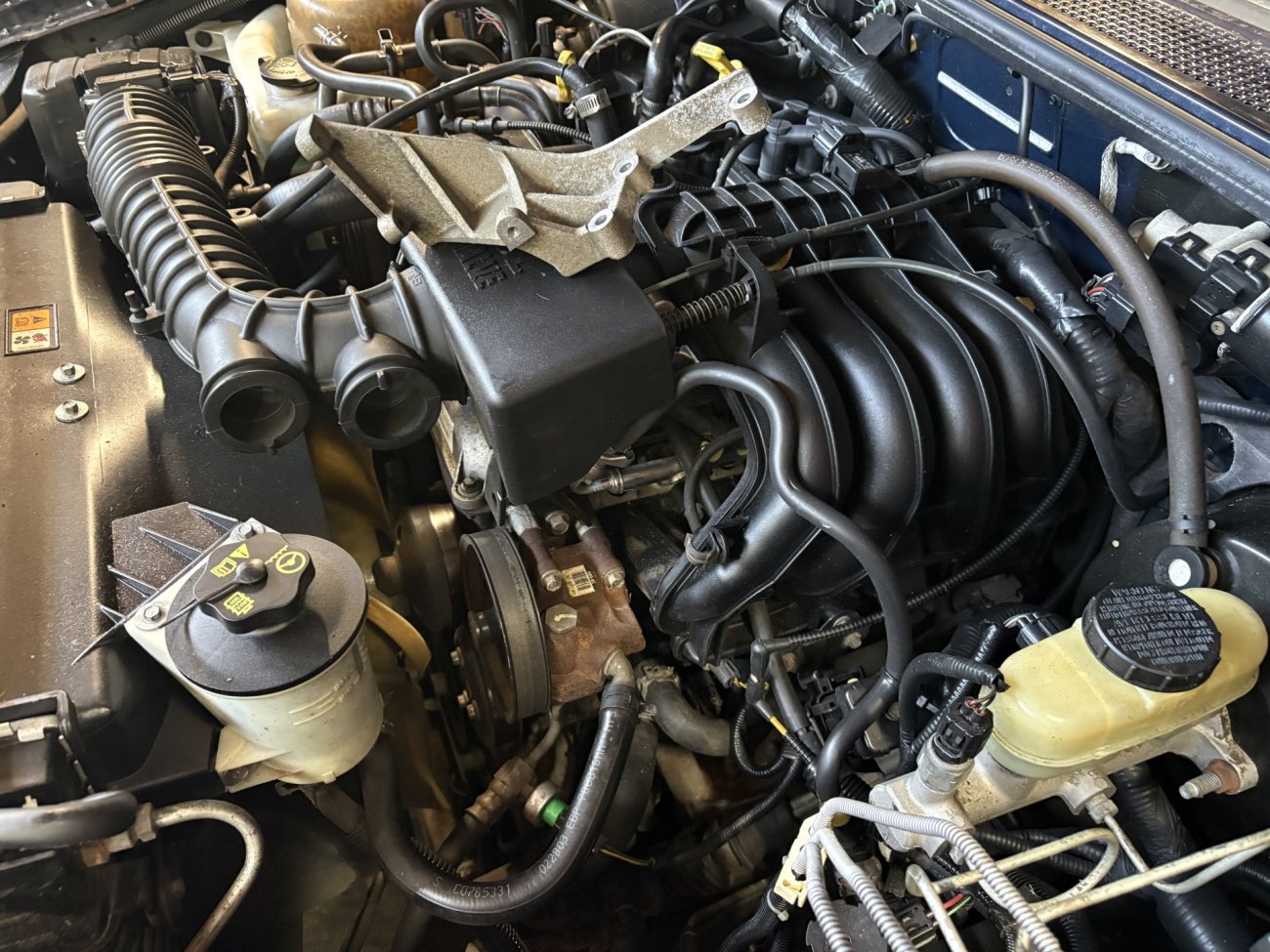 bracket removed under Hood at engine.jpg