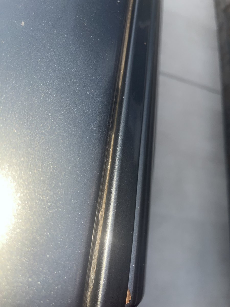 Rust under trim above rear “seat” windows