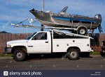 large-metal-boat-with-outboard-motor-attached-balanced-on-top-of-white-BHEP4P.jpg