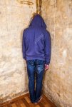 105790469-rear-view-of-a-man-in-the-corner-by-the-old-wall.jpg