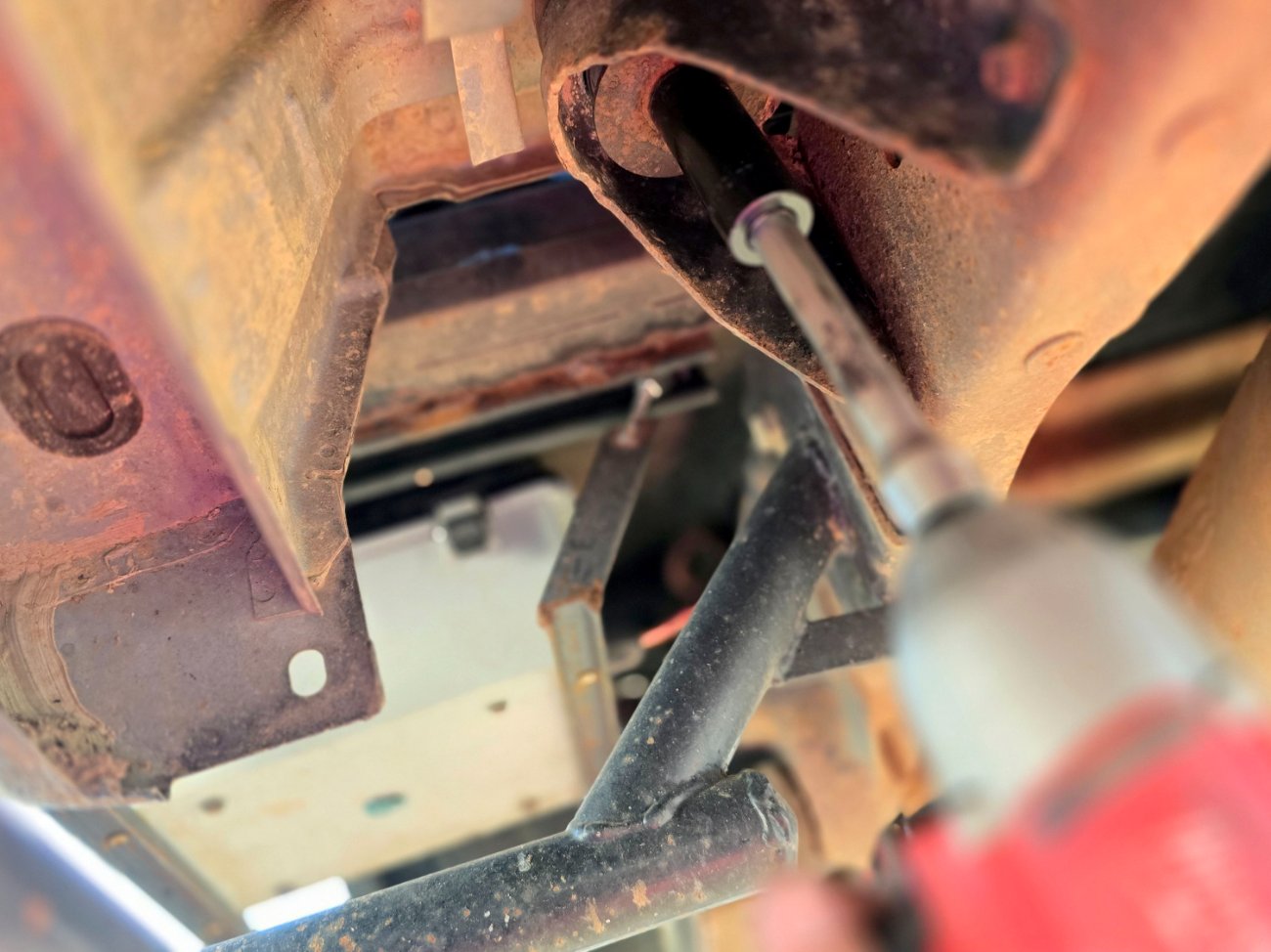 Use a 21mm socket on the nut at the bottom