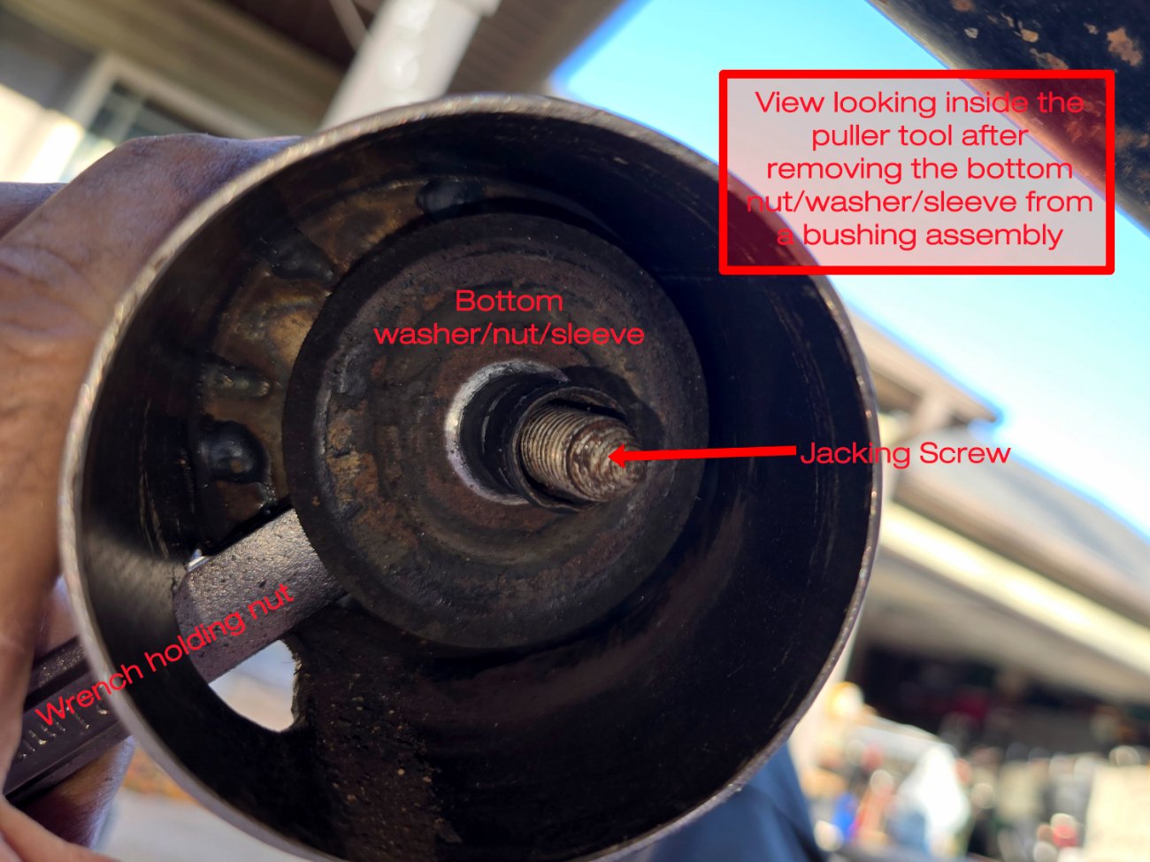 View looking inside the puller tool after removing the bottom nut, washer, sleeve from a bushing assembly