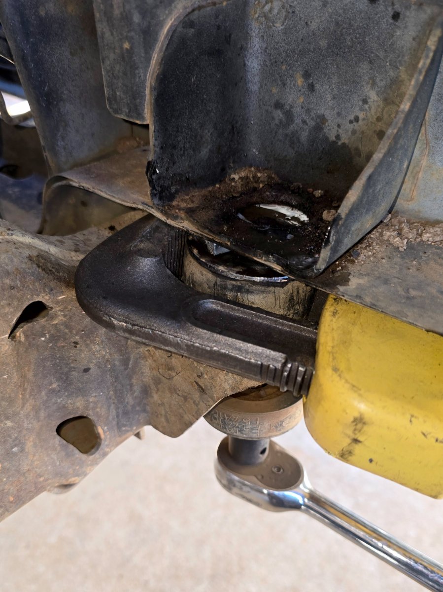 Use the pipe wrench to hold the flat washer attached to the upper sleeve.