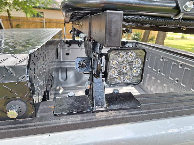 Flood light mounted to the side of the overlanding bed rack