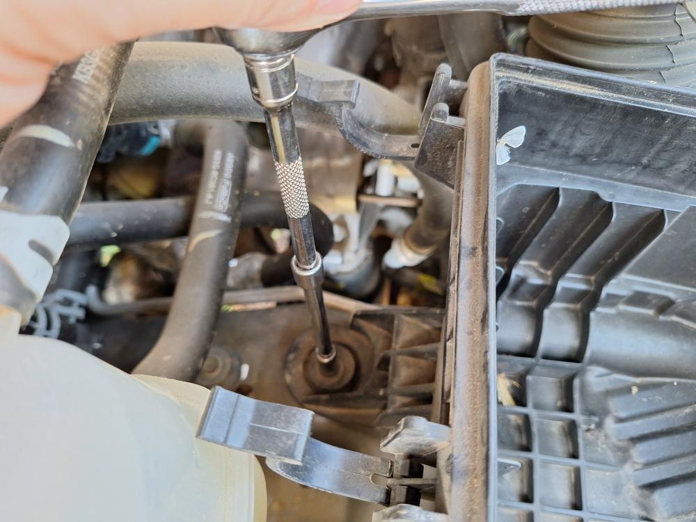 Remove bolt holding down air box
