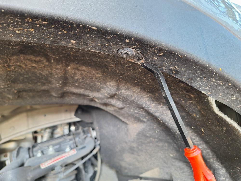 I had to remove the plastic clips that hold the fender liner in place