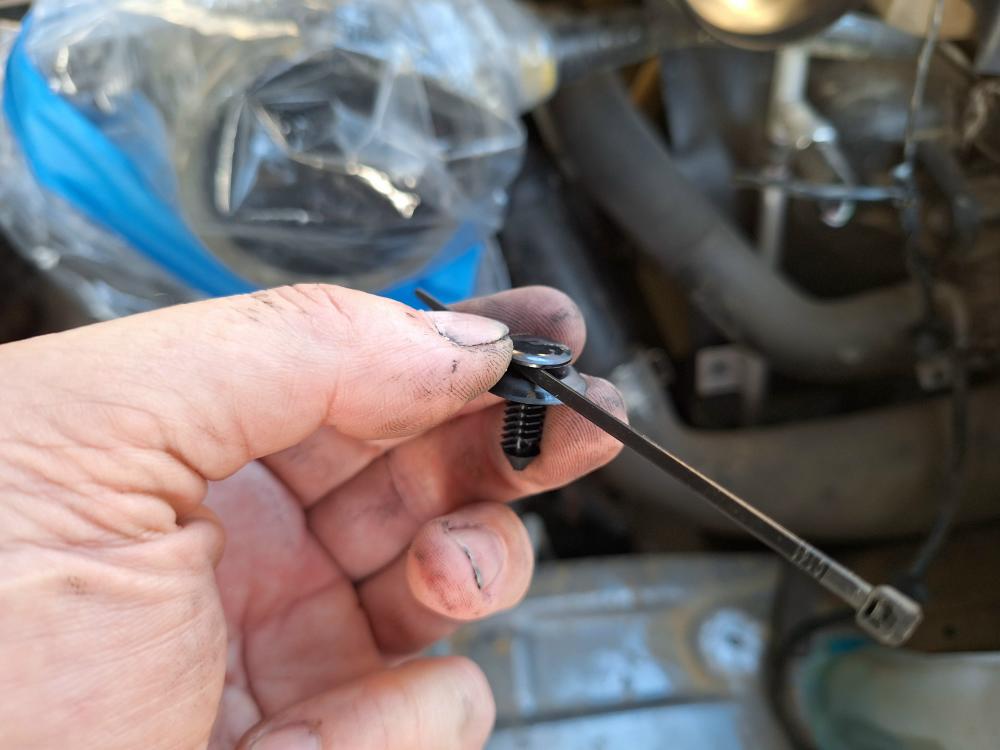 I had some plastic retaining clips and took (2) zip ties and made my own clip to hold the harness.