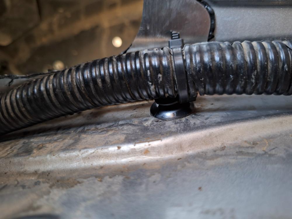 Wiring harness secured to a retaining clip with a zip tie.