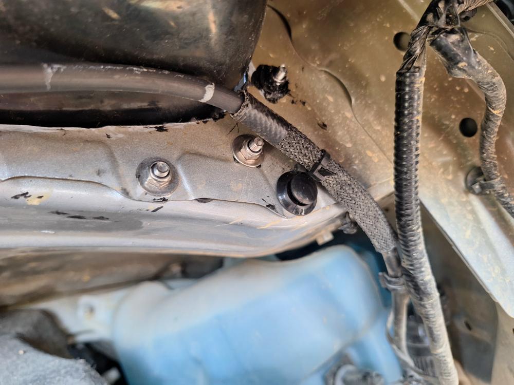 The hose has a protective coating over part of it, but I put a layer of Gorilla Tape over it to keep it from sliding and to protect it from the mounting bolts that are now sticking through right here