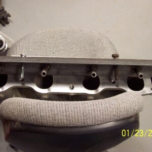 Two 7/16" bolts will bolt the jig to the intake face through the two existing holes in the manifold.