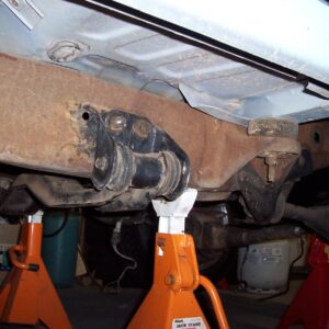 There are two sets of holes pre-drilled in the frame for the transmission crossmember mounting brackets.
