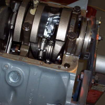 Well, out comes the motor...arrrrg.
Notice the #4 connecting rod bolts are not tight.  Somehow I must have neglected to torque those bolts when I was putting the bottom end together.... double arrrg.  The rod bolts were bent, the bearing was turned and the piston was cracked. But, the crank was fine, the rod just needed a slight touch-up at the machine shop.