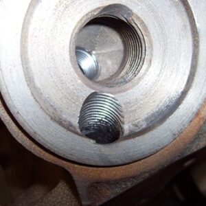 Here is a pic of the filter mount area that I drilled and tapped. I will plug the return hole (top) and attach a line to the feed hole (bottom).