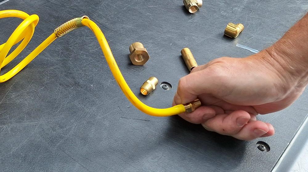 Installing 1/4-inch barbed x 1/4-inch NPT fitting in yellow hose
