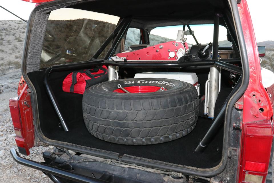 Ford Bronco II rear cargo area with roll cage and spare tire